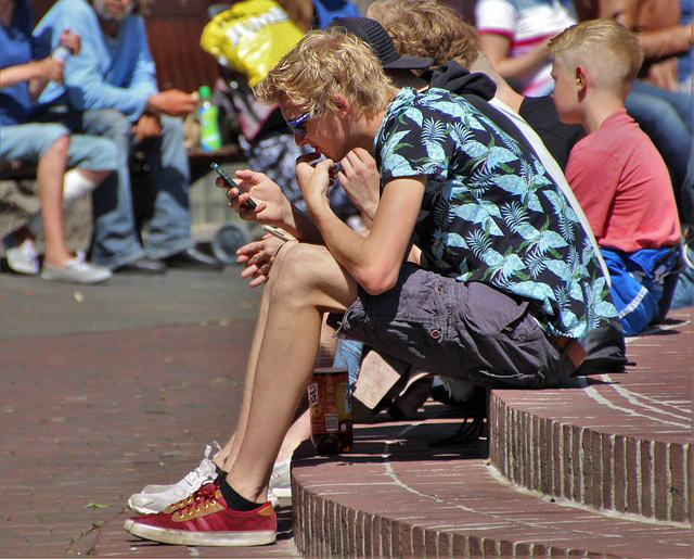 Kid on a cell phone not paying attention to his surroundings
